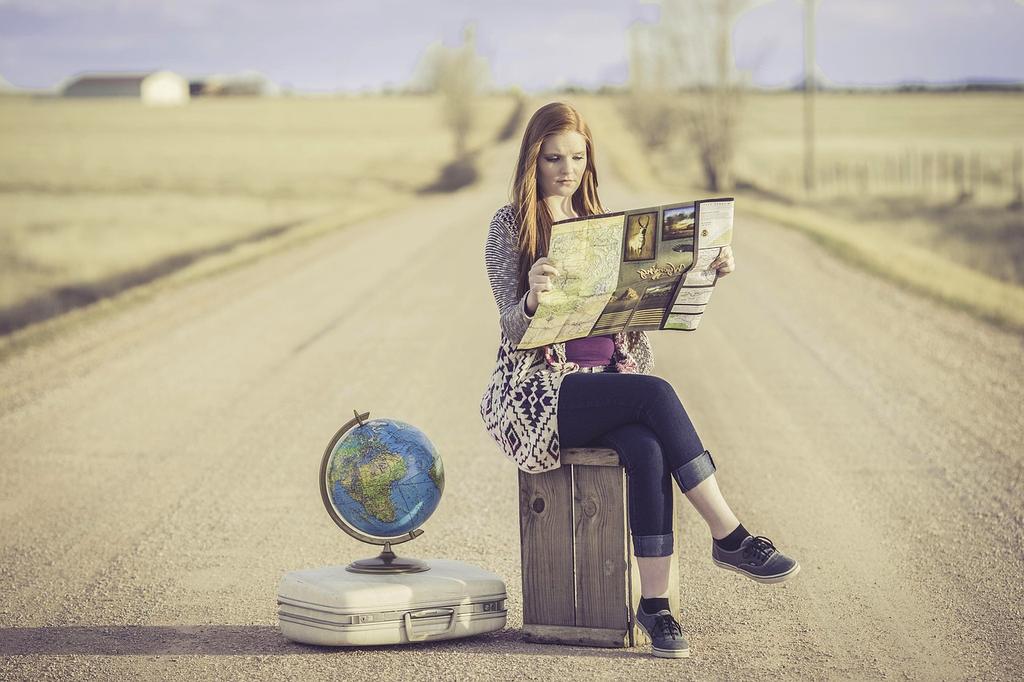 Smiling travel experts collaborating over a world map