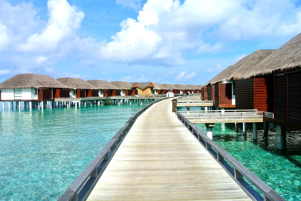 Luxurious overwater bungalow in crystal clear Maldivian lagoon