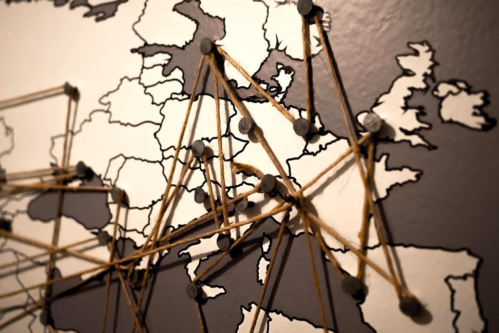 Traveler planning itinerary with map and laptop